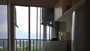 A kitchen with a view of a balcony and a lake. - dcondo mine by BP (Kathu)