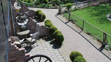 A patio area with brick steps, a table, and chairs.