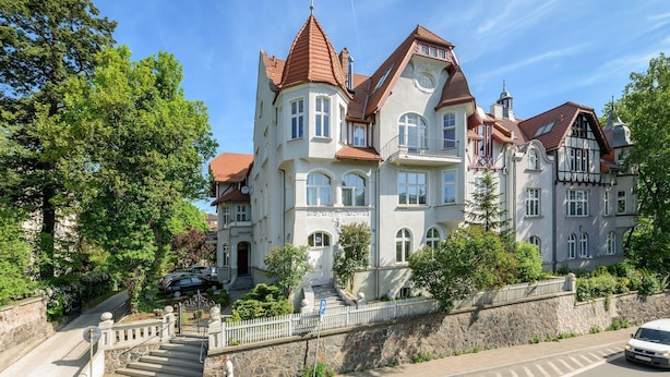 A large, historic building with multiple stories, a stone facade, and a prominent tower. - Scandi Love BestSeller by Lion Apartments Sopot (Sopot)