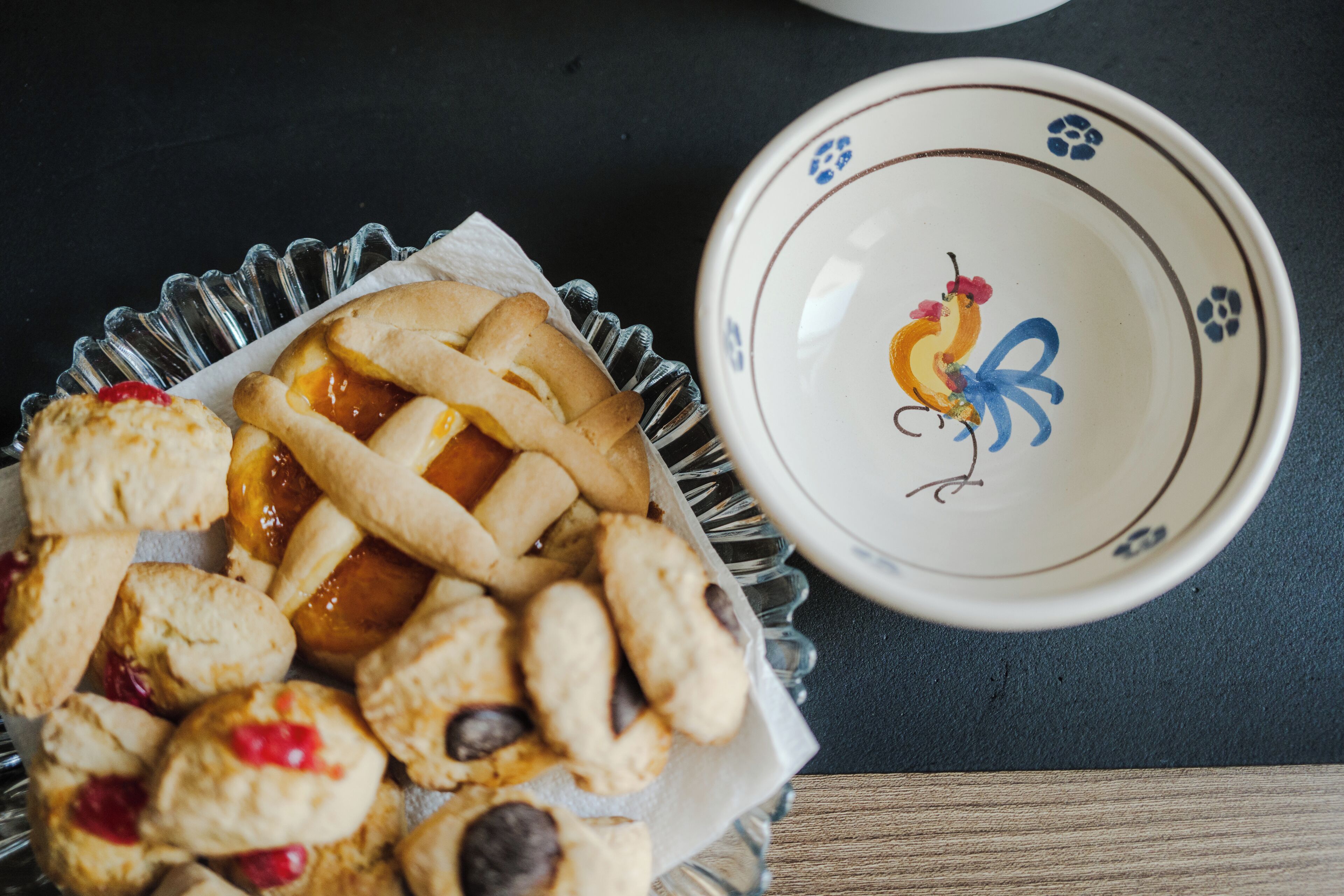 A tray of assorted pastries and a decorative bowl with a floral design.