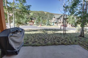 A residential area with houses, a covered grill, and a clear view of a mountain range.