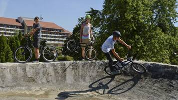A concrete ramp with a cyclist performing a trick.