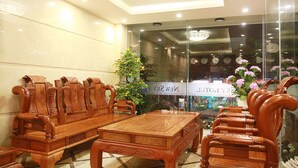 A lobby with wooden furniture, a chandelier, and a sign reading "NEW HOTEL". - New Sky Hotel (Da Nang)