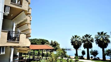 A multi-story building with balconies and outdoor seating areas.