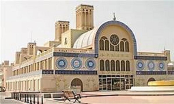 A building with a large dome and arched windows, featuring a clock and decorative circular patterns. - Hôtel Les Palmes d'Or (Houmt Souk)
