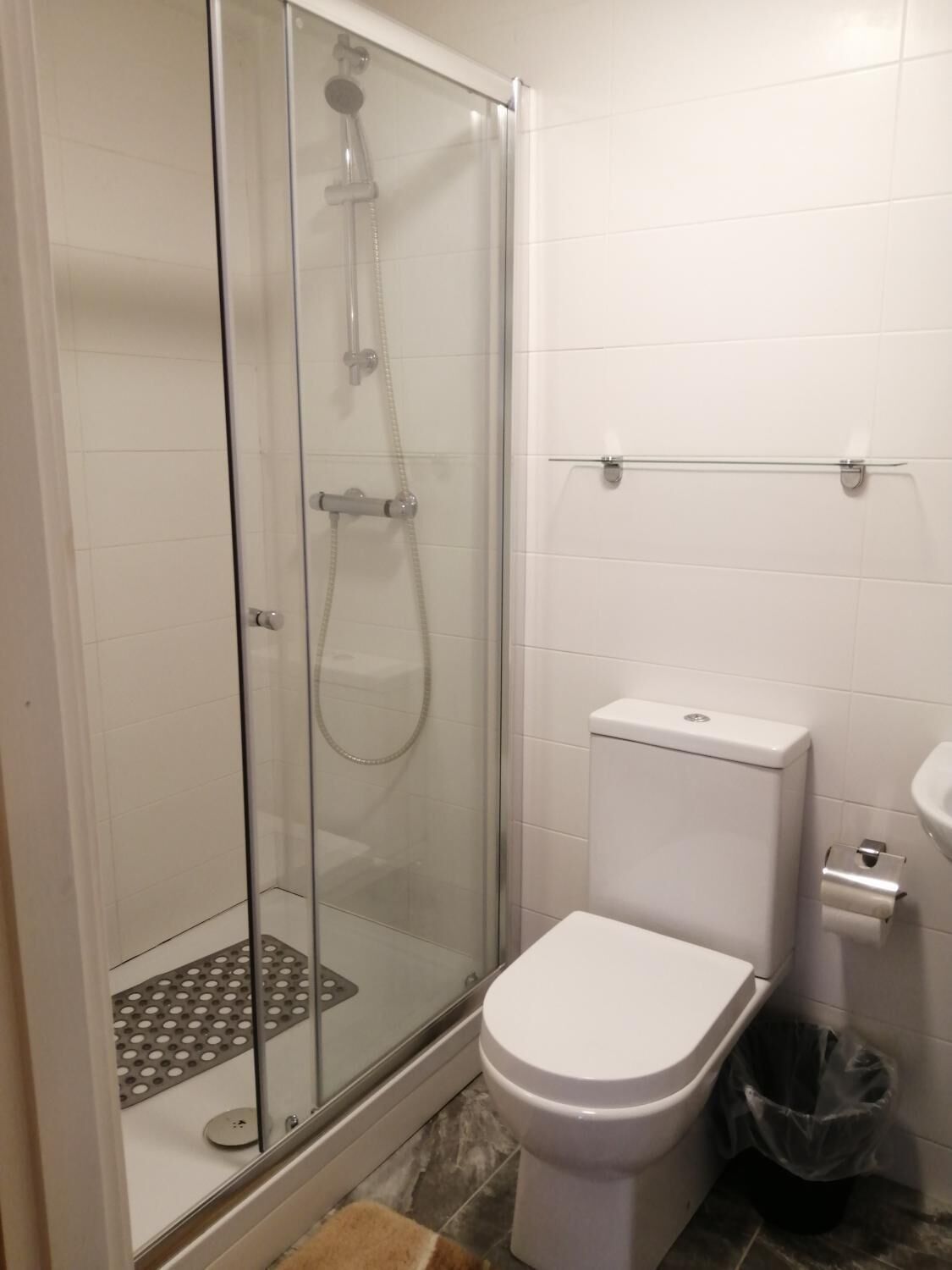 Shower, hair dryer, towels, toilet paper