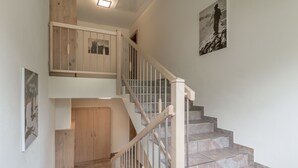 A staircase with wooden railings and stone steps, leading to an upper floor. - Residenz Allegra (Soelden)