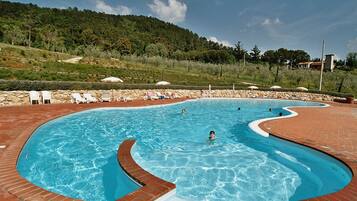 Seasonal outdoor pool, open 9:00 AM to 8:00 PM, pool umbrellas