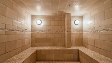 Spacious indoor area with large tile walls and grid-patterned floor.