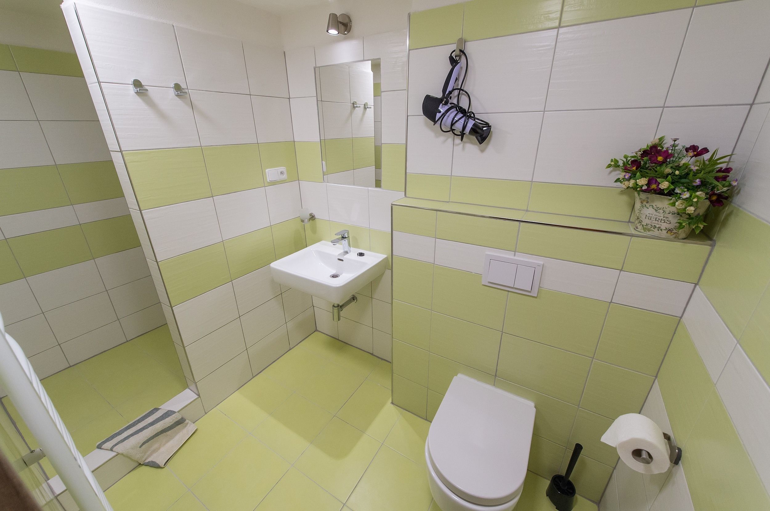A bathroom with a sink, toilet, and shower.