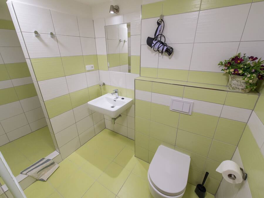 A bathroom with a sink, toilet, and shower.