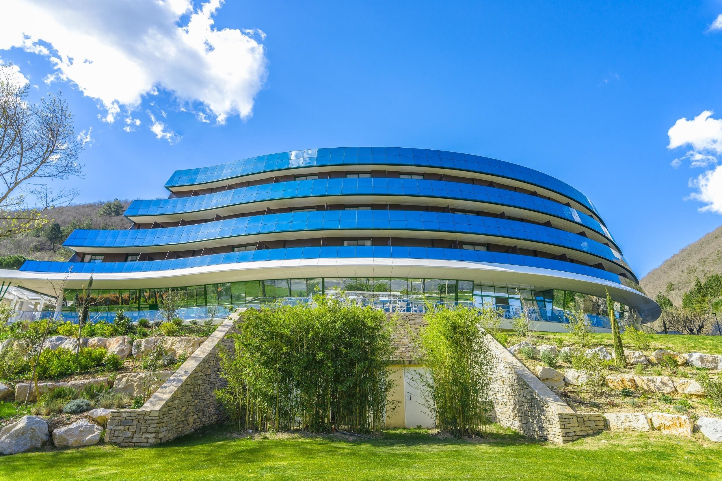 A modern building with a curved design and multiple levels.