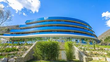 A modern building with a curved design and multiple levels.
