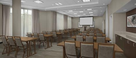 A conference room with multiple tables and chairs, a projector screen, and a large window with curtains.