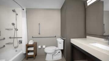 A modern bathroom with a bathtub, toilet, and sink.
