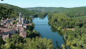 A riverside town with historic buildings and a prominent church.