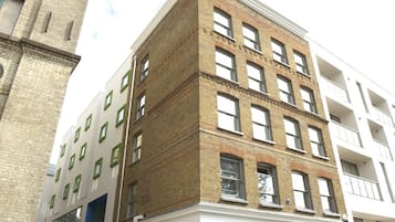 A multi-story building with a brick facade and multiple windows.