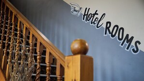 A wooden staircase with a sign reading "Hotel Rooms" on the wall. - White Hart, Newmarket by Marston's Inns (Newmarket)
