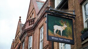 A sign for White Hart Hotel with a deer illustration. - White Hart, Newmarket by Marston's Inns (Newmarket)