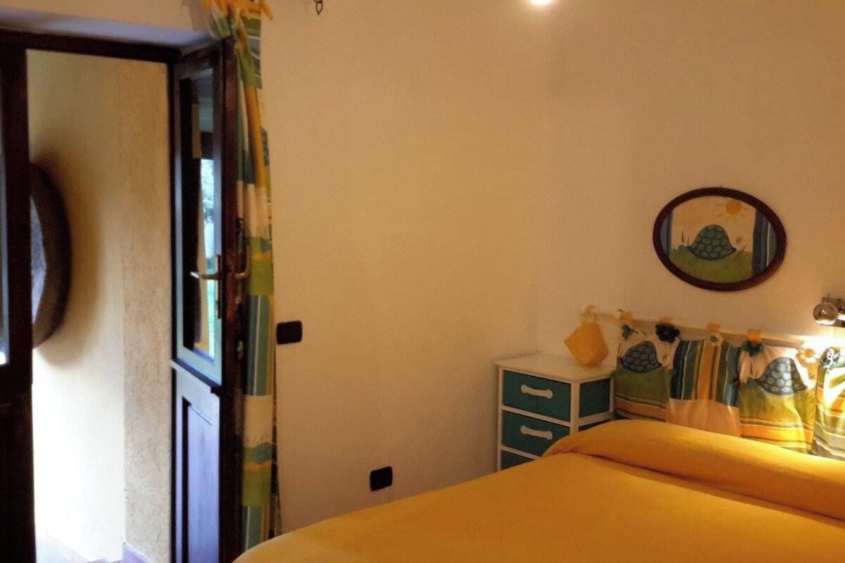 Un dormitorio con cama, cómoda y espejo instalado en la pared.