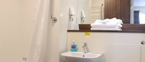 A bathroom with a bathtub, a sink, a toilet, and a shower.
