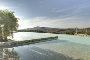 Outdoor pool, open 9 AM to 7 PM, pool umbrellas, pool loungers