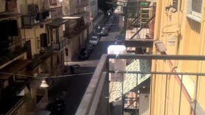 A narrow street with parked cars and buildings on either side. - B&B Anny (Naples)