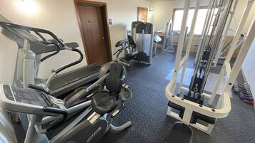 A gym with treadmills, elliptical machines, and weight machines.
