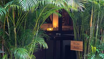 A room with a dark wooden desk, a lamp, and a sign reading 'Studio Amor'.