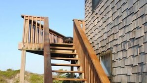 A wooden staircase leading to a building with a shingled exterior. - Avon Cottages (Avon)