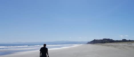 Beach nearby, white sand, beach towels