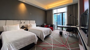A hotel room with two beds, a desk, a chair, a TV, and a view of the cityscape. - theRED (Kuala Lumpur)