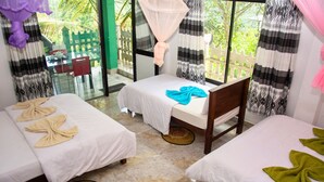A hotel room with two beds, a dining table, and a view of the outside. - 9 Arch View Rest Inn (Ella)