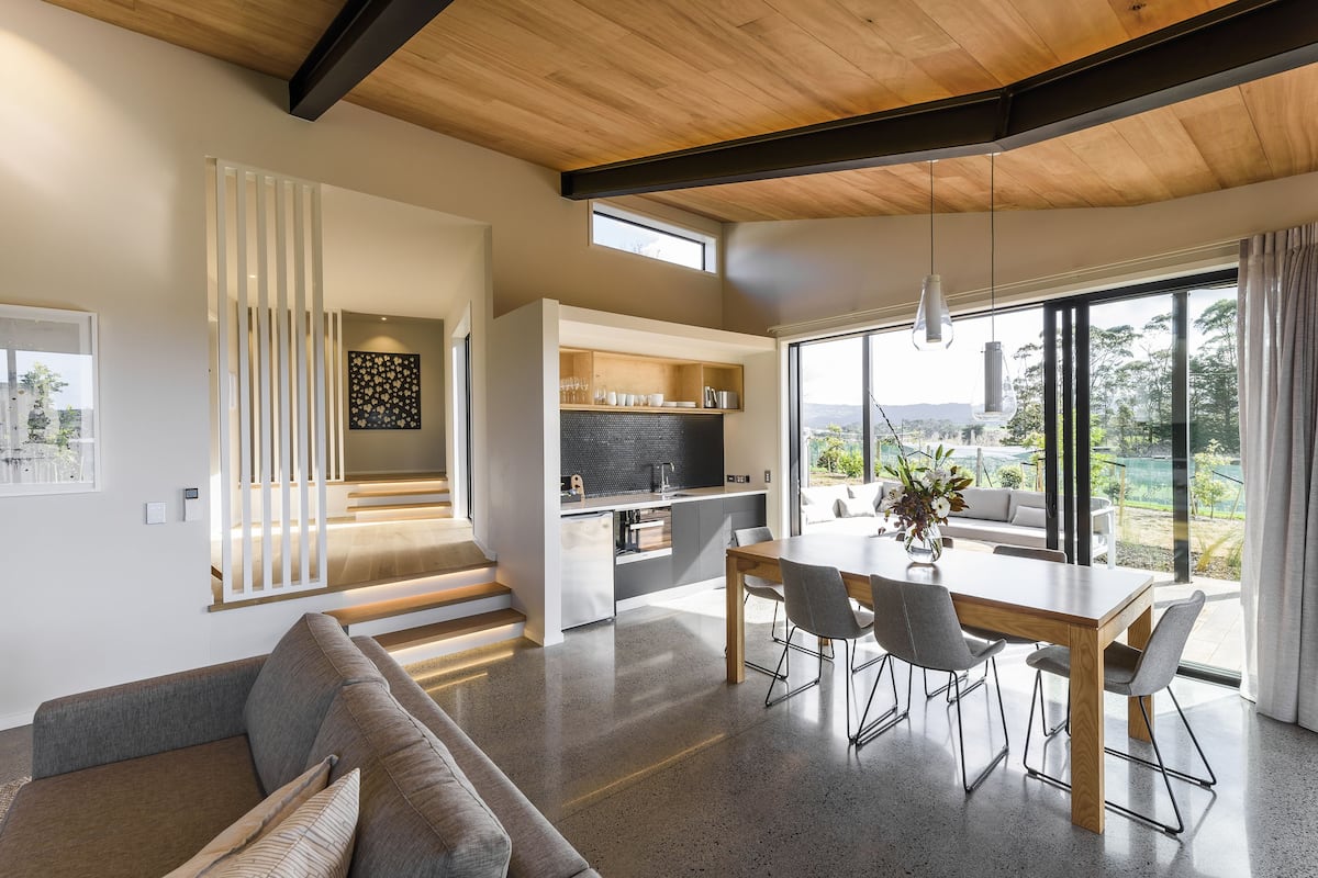A modern interior with a dining area, kitchen, and living space.