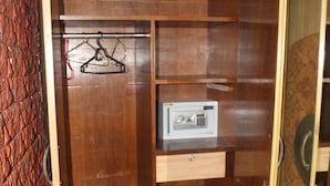 A wooden wardrobe with a built-in safe, shelves, and a hanging space. - Mama Mids Home (Morjim)