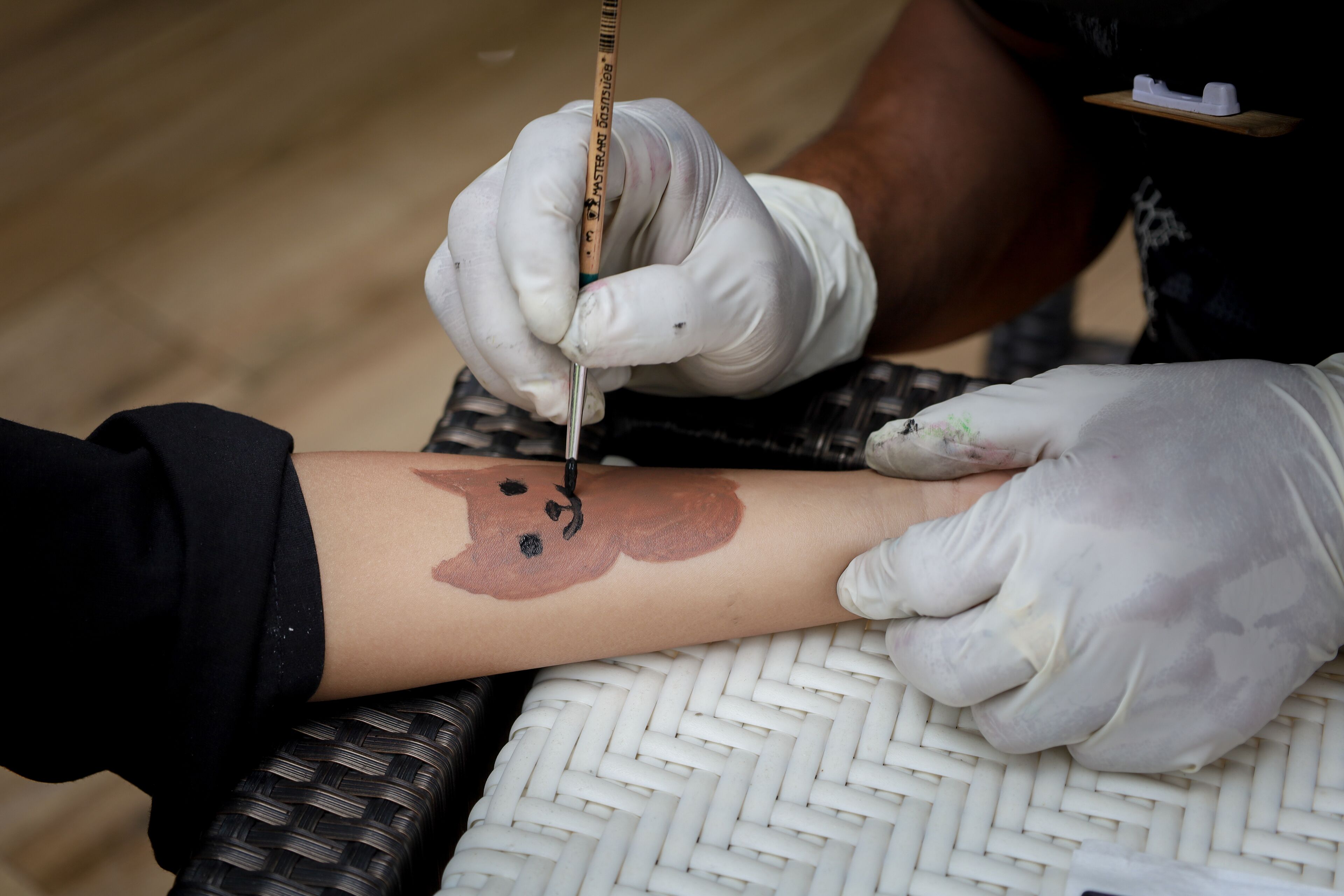 A person getting a tattoo on their arm.