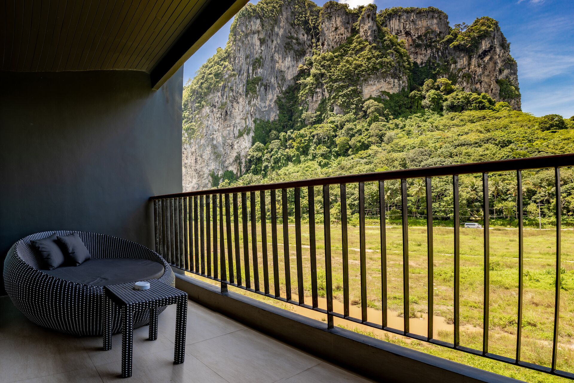 A balcony with a view of a mountainous landscape.