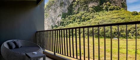 A balcony with a view of a mountainous landscape.