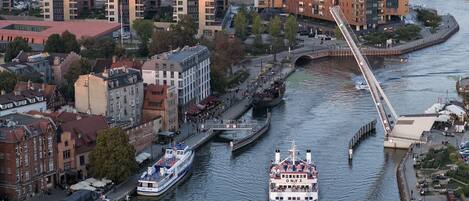 A river with boats, a bridge, and buildings along the riverbanks.