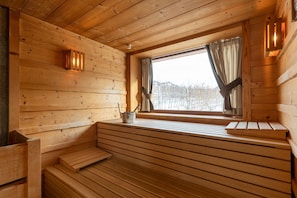 A wooden cabin interior with a bench, a window with curtains, and a small table with a kettle. - Agriturismo Il Tempo delle Mele (Caldes)
