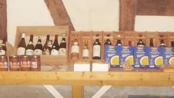 A wooden table with various wine bottles and boxes, likely in a cellar or storage area.