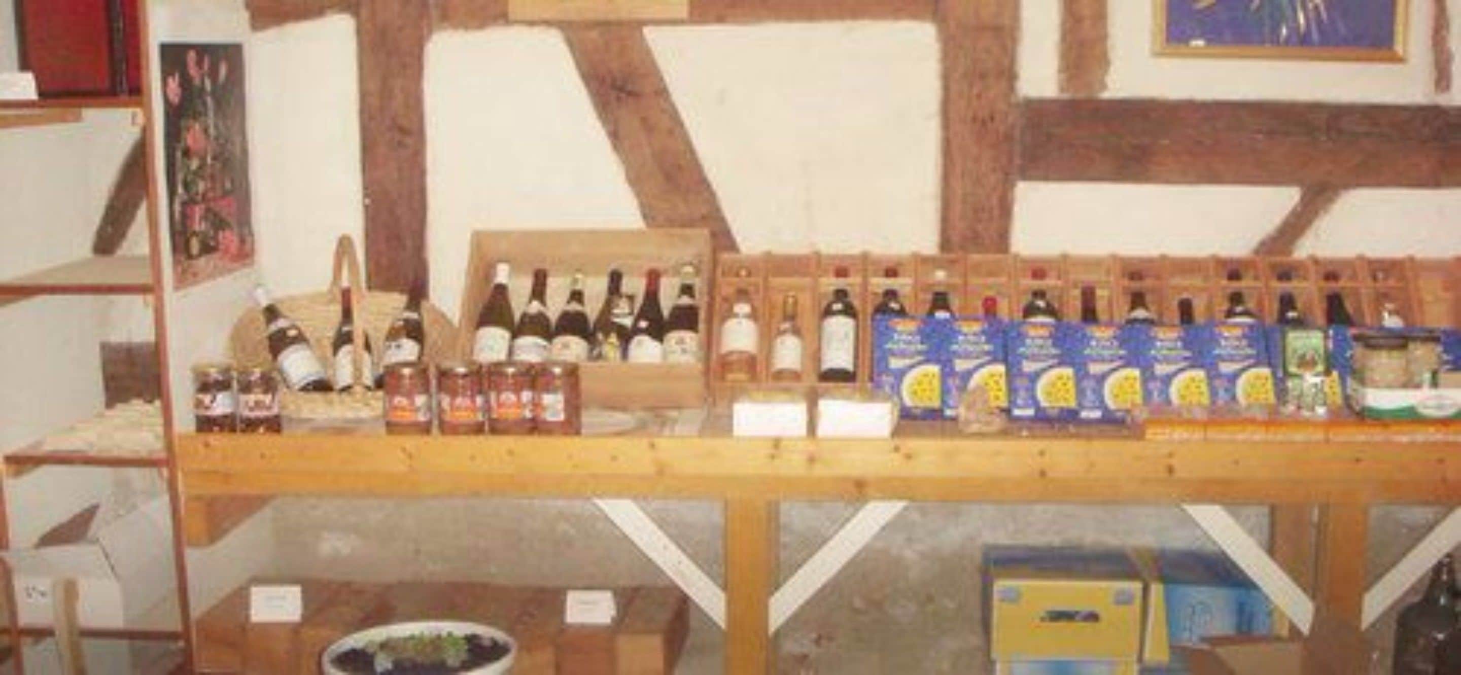 A wooden table with various bottles and boxes, likely containing beverages or food items.