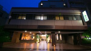 A hotel entrance with a modern facade, a visible sign indicating it is a hotel, and a well-lit entrance area. - Hotel Seishokan (Shizuoka)