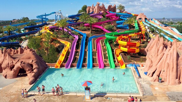 A water park with multiple colorful water slides and a pool area. - Villa Prana Guesthouse, Yoga & Ayurveda (Portimão)