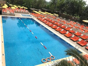 Seasonal outdoor pool, open 10:00 AM to 6:00 PM, pool umbrellas