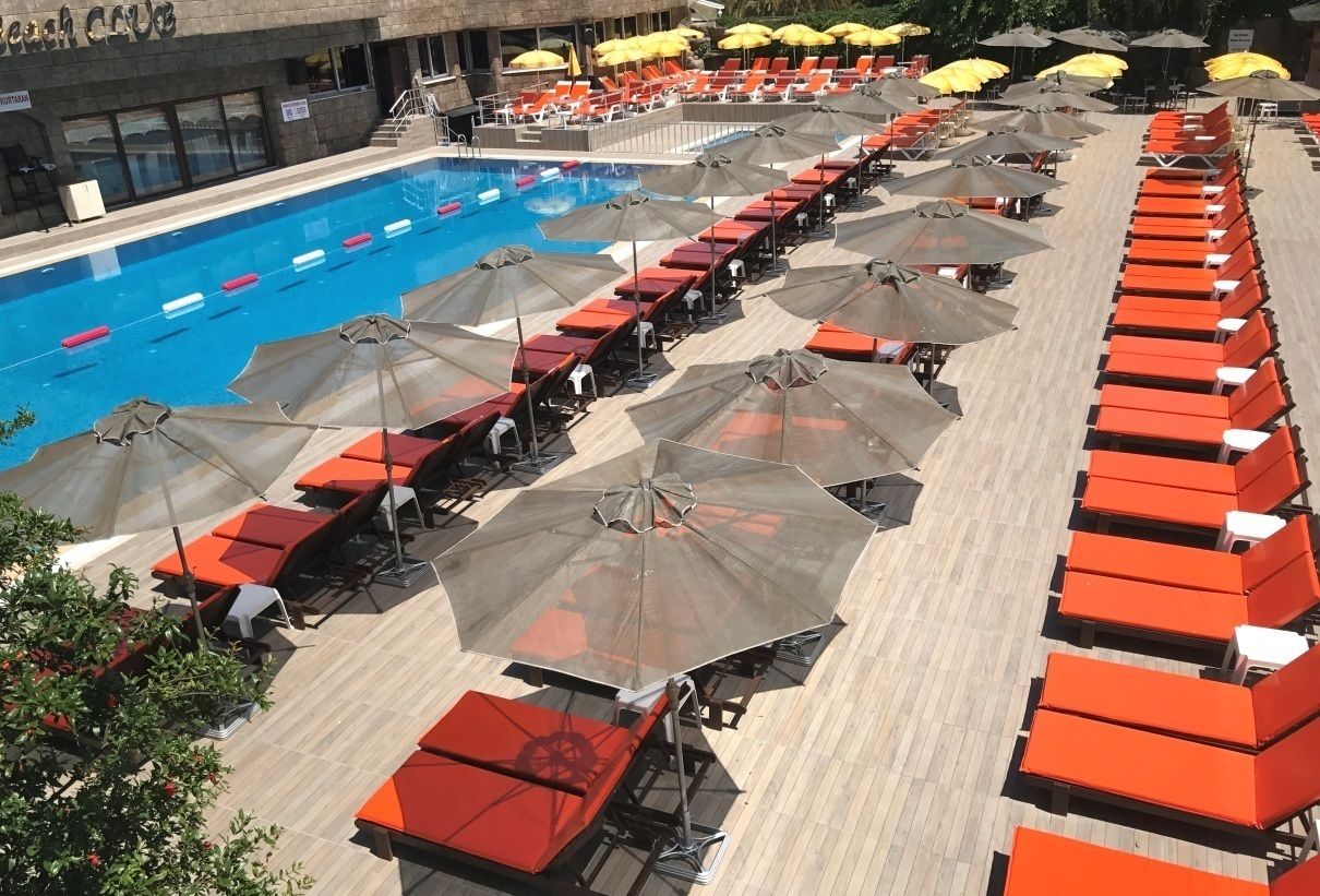 Seasonal outdoor pool, open 10:00 AM to 6:00 PM, pool umbrellas