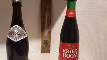 Zwei Flaschen Kriek Boon auf einem Regal.