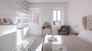 A bedroom with a bed, a chair, a desk, and a window. - Rent In Rome - Vittoria Terrace (Rome)