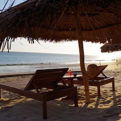 On the beach, white sand, sun-loungers, beach umbrellas