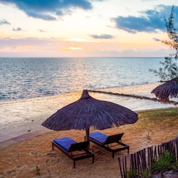 On the beach, white sand, sun loungers, beach umbrellas